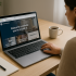 A New Zealand small business owner compares website platforms on a laptop. The screen shows tabs for WordPress, Wix, and Squarespace. A notepad, pen, and coffee cup are on the desk, symbolising the decision-making process for choosing a website builder. WordPress vs Wix